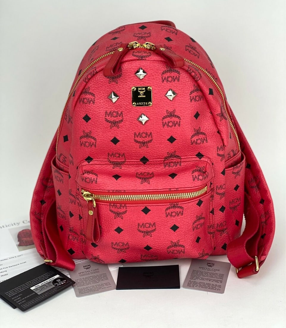 MCM Backpack Red Studs Cognac Visetos Leather Stark Backpack B380: MCM Backpack Red Studs Cognac Visetos Leather Stark Backpack B380 Bag Width: 10.25 in Shape: Rectangle Closure: Zip Handle/Strap Color: Red Size: Medium Hardware Color: Gold Bag Depth: 5 in Fabric Typ