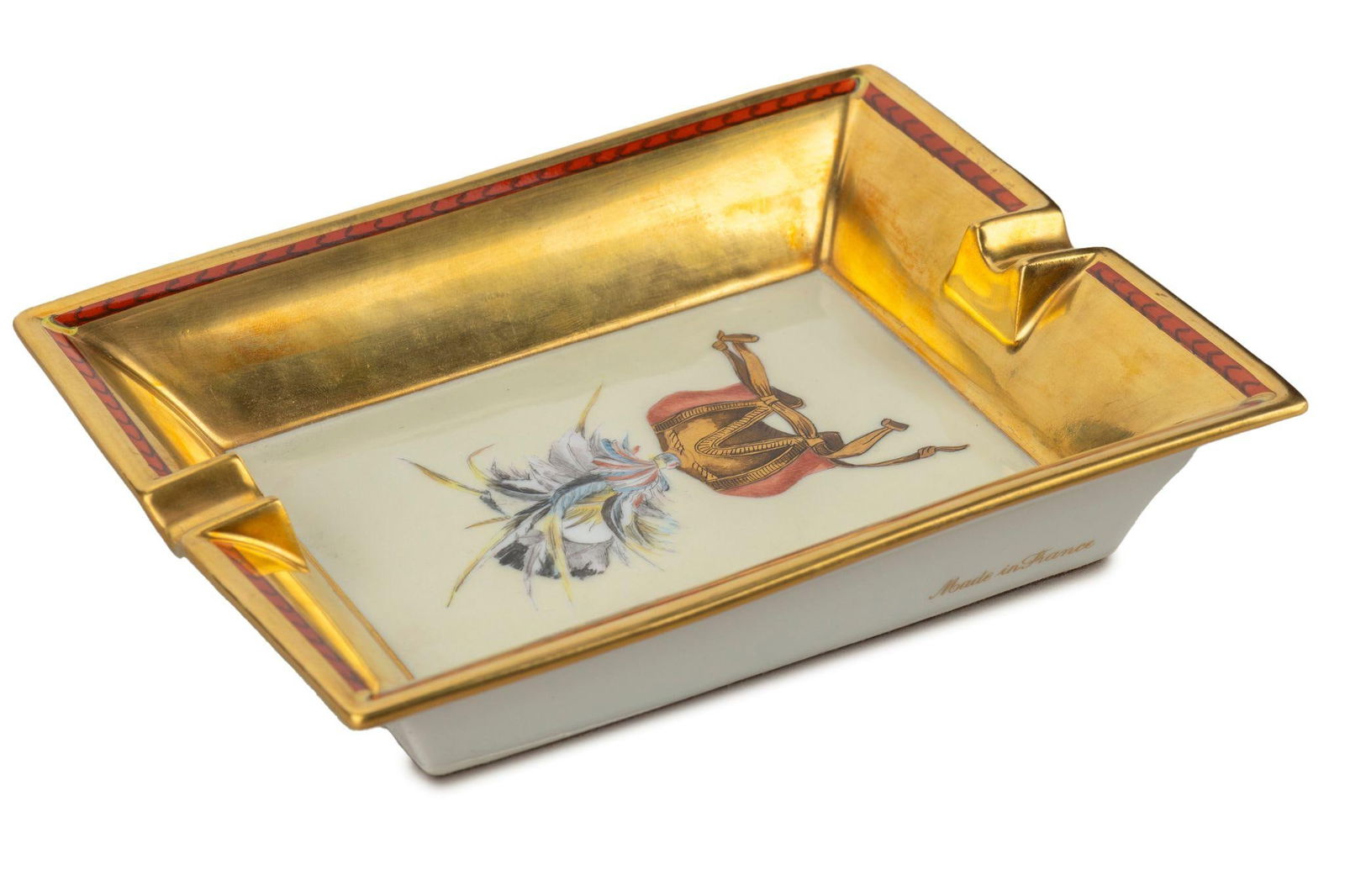 Hermes Gold Foil Porcelain Ashtray: Hermes Gold Foil Porcelain Ashtray Brand: Hermes Dimensions: Height: 6.25 in (15.88 cm)Width: 1.5 in (3.81 cm)Length: 7.75 in (19.69 cm) Place of Origin: France Period: 20th Century Pre-Owned The BIDH