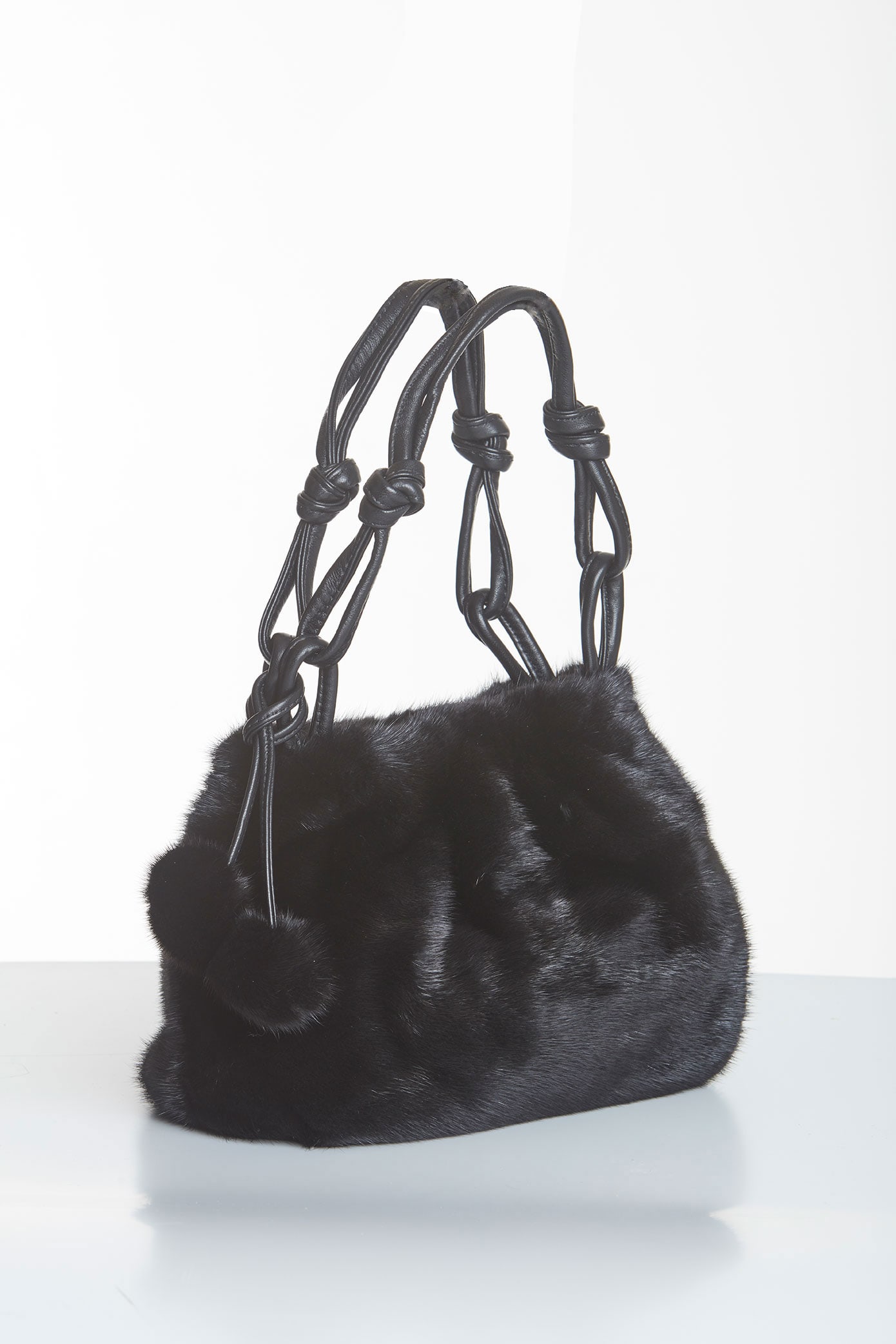 Mink Fur Handbag - Midsize - Black Mink Pom Poms: Mink Fur Handbag - Midsize - Black Mink Pom Poms You've finally found a bag that can carry you from day into night. Start your day with a boost - with this lovely mink bag you have room for all your d