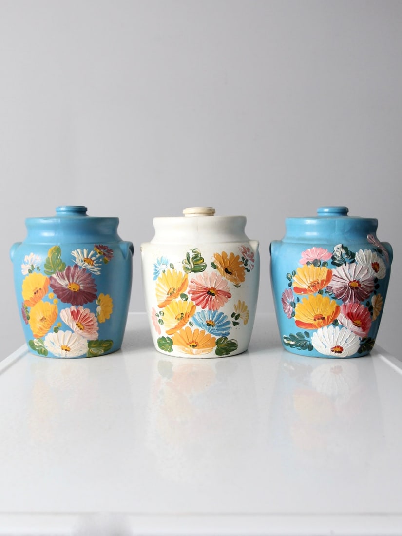 Ransburg Pottery Cookie Jar Collection Of 3: Ransburg Pottery Cookie Jar Collection Of 3 This is a collection of three vintage Ransburg Pottery cookie jars circa 1930s. Hand-painted flowers colorfully display across the fronts. The collection fe