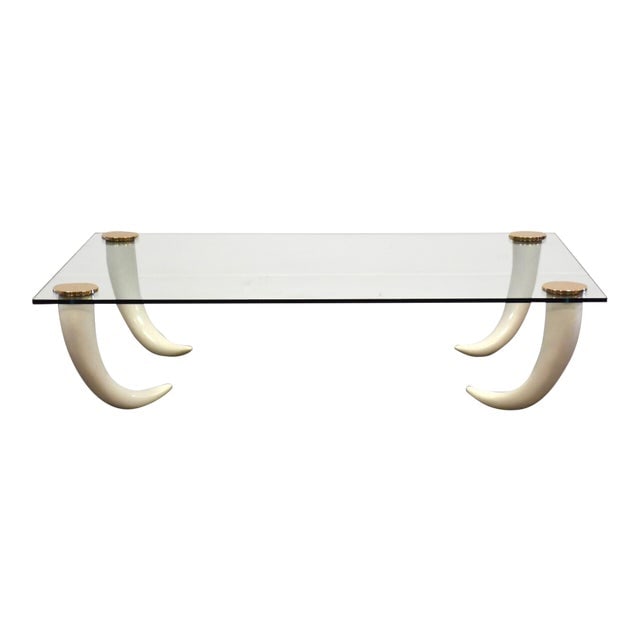 Glass Bronze & Faux Tusk Modern Coffee Table: Glass Bronze & Faux Tusk Modern Coffee Table A mid century modern glass coffee table with polished bronze detail and faux elephant tusk legs in the style of Maison Jansen. 60" wide. 40" deep. 14.75" t