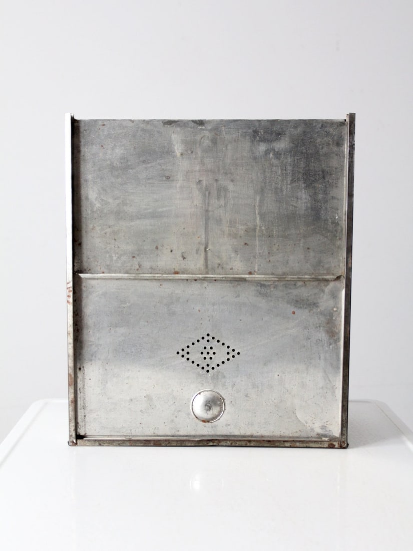 Vintage Metal Bread Box: Vintage Metal Bread Box This vintage metal bread box with sliding door is a great storage solution. The reflective aluminum box features a sliding door with a decorative perforated vent. Use it in the