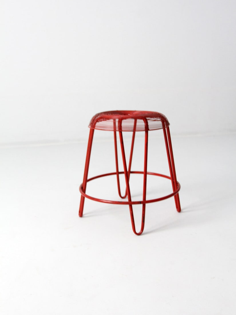 Mid-Century Hairpin Leg Stool: Mid-Century Hairpin Leg Stool This is a mid-century modern red metal stool. Thin wires of metal shape the rounded seat as hairpin legs add to the style. Height 17.5 inch 44.5 cm Diameter 17 inch 43.2 