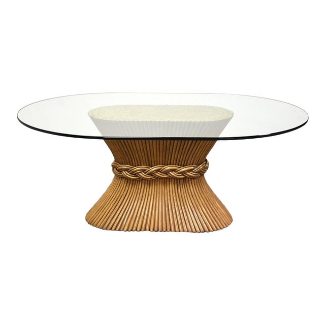 McGuire Sheaf of Wheat Rattan Dining Table: McGuire Sheaf of Wheat Rattan Dining Table A rattan bamboo chic sheaf of wheat dining table made by McGuire with an oval glass top. No chips. 70" wide. 48" deep. 28.25" tall. Dimensions: 70"W x 48"D x