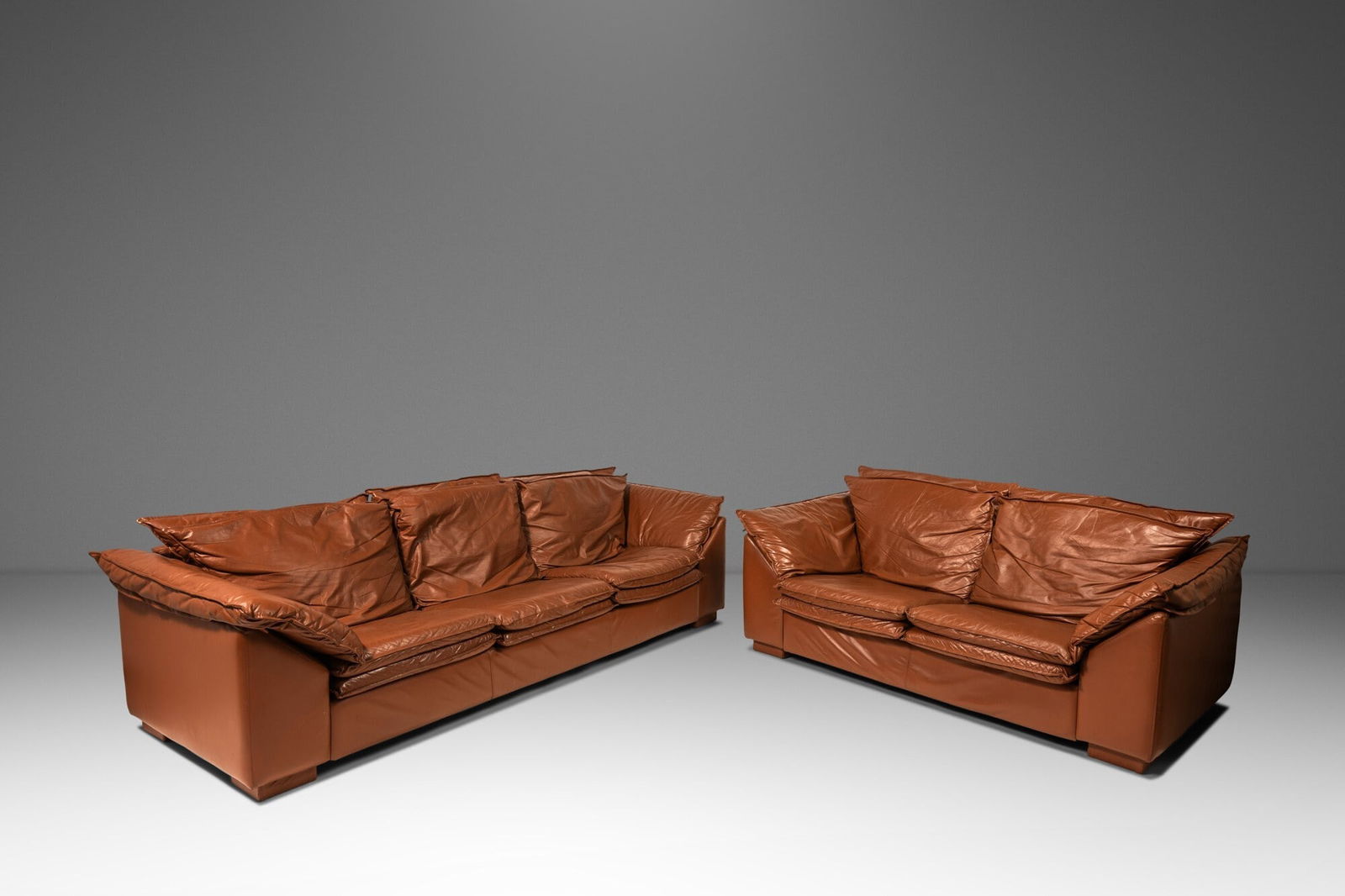 Set of Two (2) Modern Low Profile Sofas in Cognac Brown Leather in the Manner of Niels Eilersen USA: Set of Two (2) Modern Low Profile Sofas in Cognac Brown Leather in the Manner of Niels Eilersen USA c. 1990s Set of Two (2) Modern Low Profile Sofas in Cognac Brown Leather in the Manner of Niels Eile