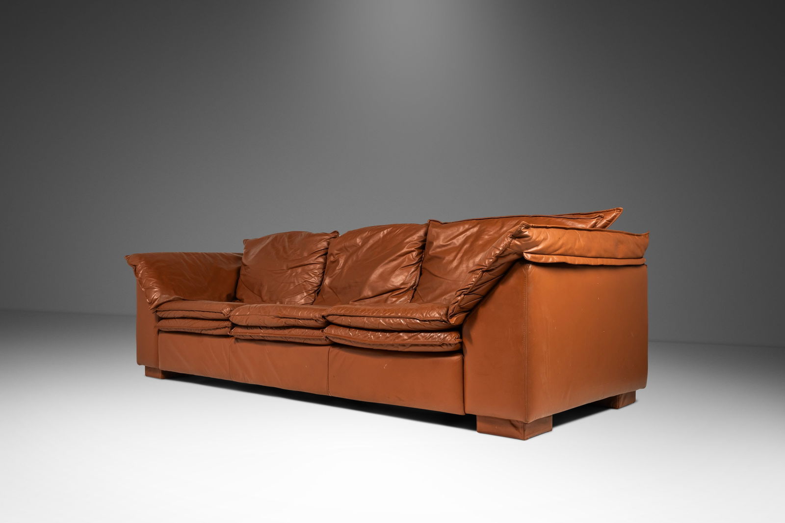 Modern Low Profile Three-Seater Sofa in Cognac Brown Leather in the Manner of Niels Eilersen USA: Modern Low Profile Three-Seater Sofa in Cognac Brown Leather in the Manner of Niels Eilersen USA c. 1980s Modern Low Profile Three-Seater Sofa in Cognac Brown Leather in the Manner of Niels Eilersen U