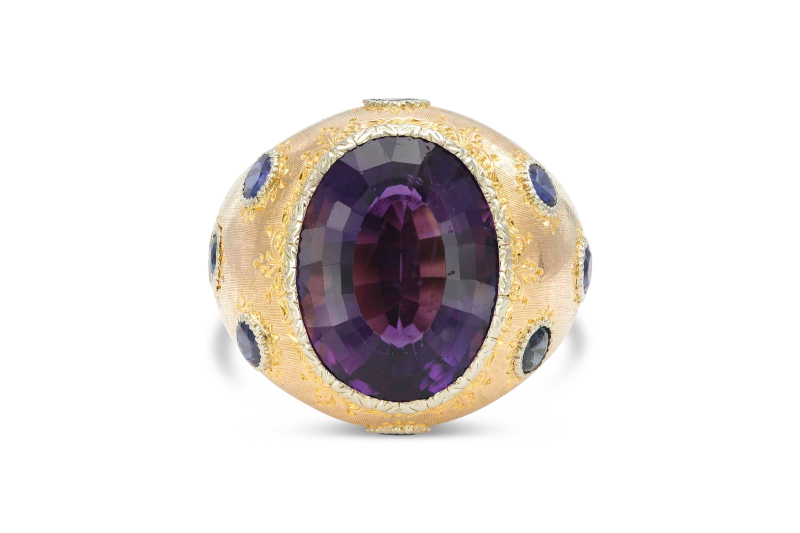 Buccellati Amethyst and Sapphire Ring: Buccellati Amethyst and Sapphire Ring Finely crafted in 18K yellow gold with a center amethyst stone and surrounding sappires.Size 6 3/4.Signed by Buccellati. The BIDHAUS Guarantee: All items in this