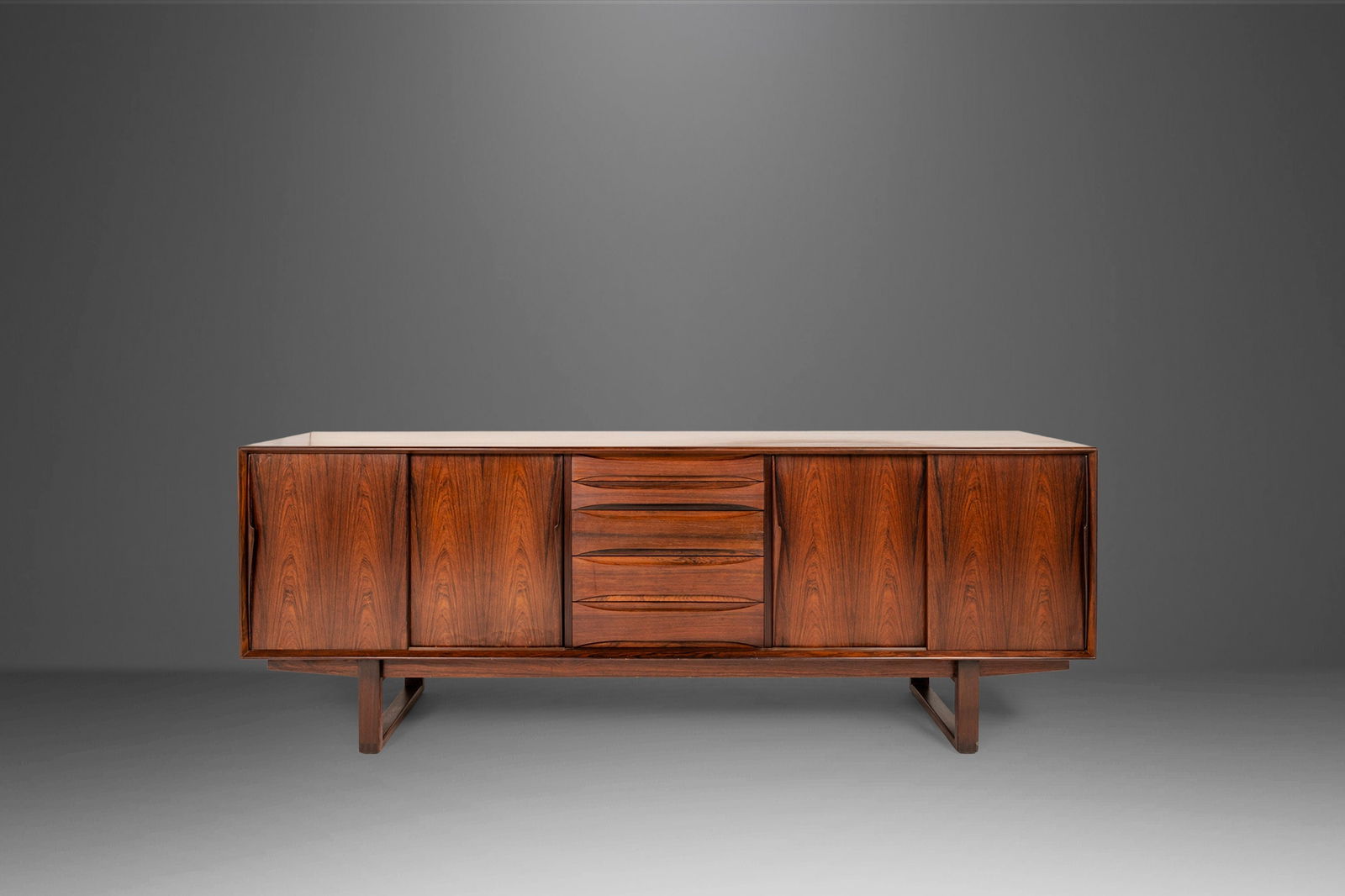 Danish Modern Rosewood Credenza by Arne Vodder 1960s 87 inches Wide Sled Base: Danish Modern Rosewood Credenza Set on a Sled Base Attributed to Arne Vodder Denmark 1960s Danish Modern Rosewood Credenza Set on a Sled Base Attributed to Arne Vodder Denmark 1960s About: Equal parts