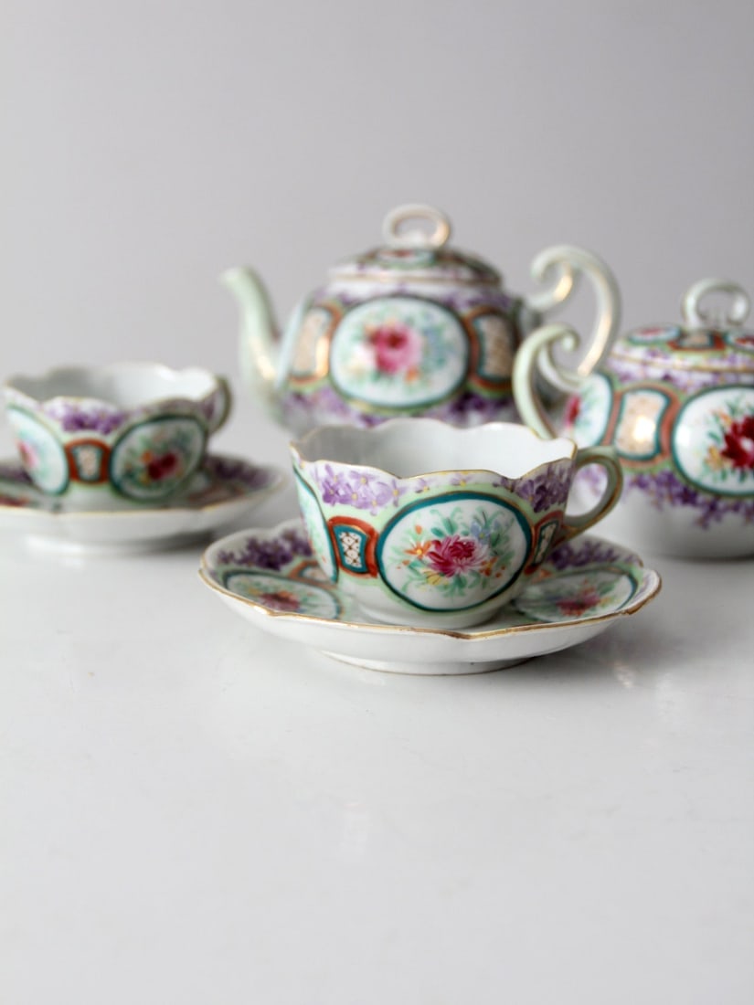 Antique Floral Porcelain Tea Set with Gold Trim Tea Pot Creamer Sugar Bowl Cups: Antique Floral Porcelain Tea Set This is an antique porcelain tea set. Featuring a beautiful floral pattern with gold trim the set includes a tea pot creamer sugar bowl two cups and two saucers. Lengt
