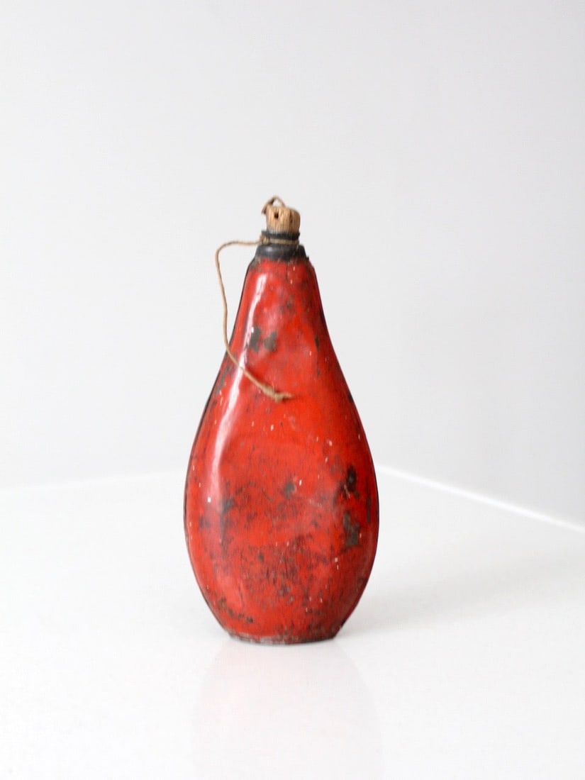 Vintage Red Metal Canteen with Cork Top 8.75 inches Height 4.5 inches Width: Vintage Red Metal Canteen This vintage red metal container has a cork top. The burnt red flask has great color and character. The cork top is detached from it string. Height with cork 8.75 inch 22.2 c