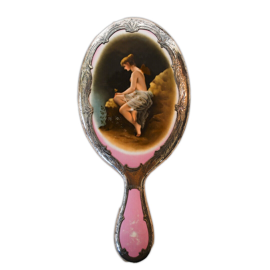 Antique Porcelain Mirror with Silver Overlay 11in Height Young Maiden Butterfly: Antique Porcelain Mirror with Silver Overlay Discover the Antique Porcelain Mirror with Silver Overlay. This piece displays a young maiden with small wings on her back accompanied by a butterfly. Meas