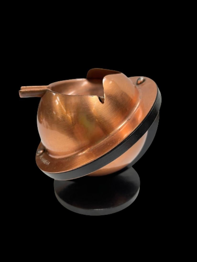 Art Deco Bakelite and Copper Saturn Ashtray: This original Art Deco ashtray from the 1930s features a unique Saturn design, crafted from Bakelite and copper. Perfect for collectors, this piece showcases the distinctive style of the period. The c