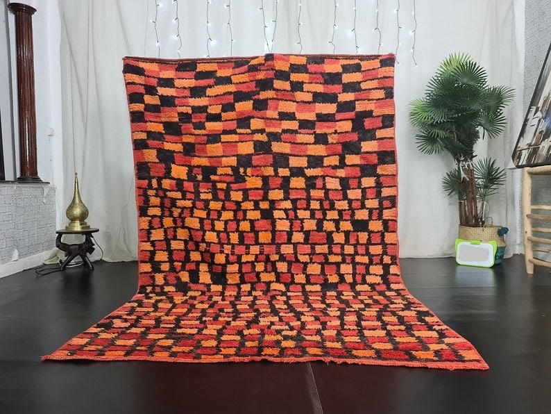 Handmade Moroccan Berber Wool Rug 9.84 x 6.56 ft: This stunning handmade Moroccan Berber rug is crafted from 100% local sheep wool by skilled women weavers in the Middle Atlas Mountains. Its vibrant colors and intricate patterns reflect the rich cult