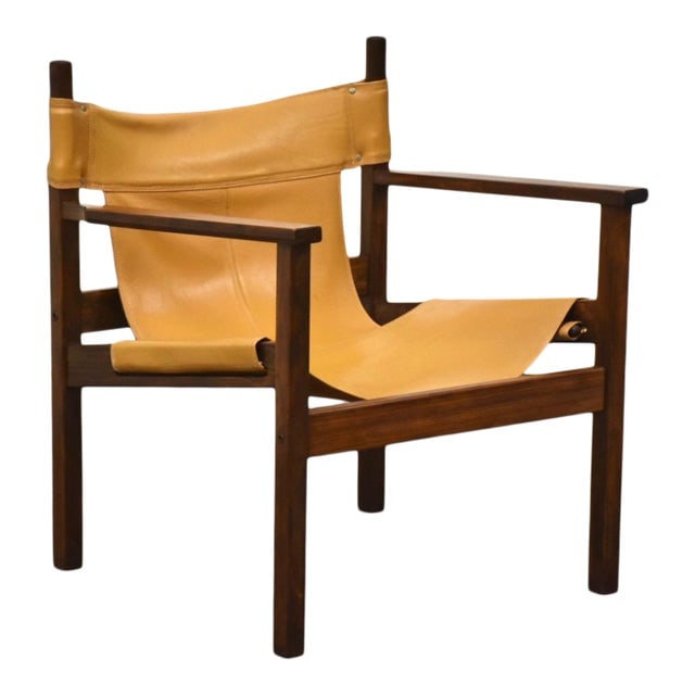 Mid Century Leather Safari Sling Lounge Chair: This mid-century modern lounge chair, inspired by Michel Arnoult, features a luxurious brown saddle leather sling design. With a seat height of 13 inches, the chair measures 25 inches in width, 24 inc
