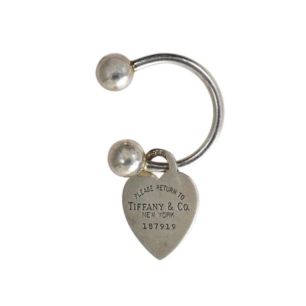 Tiffany & Co Keychain with Heart Tag 10.3g: This elegant Tiffany & Co keychain features a charming heart tag, adding a touch of luxury to your everyday essentials. Crafted with precision, this piece is perfect for collectors or as a thoughtful