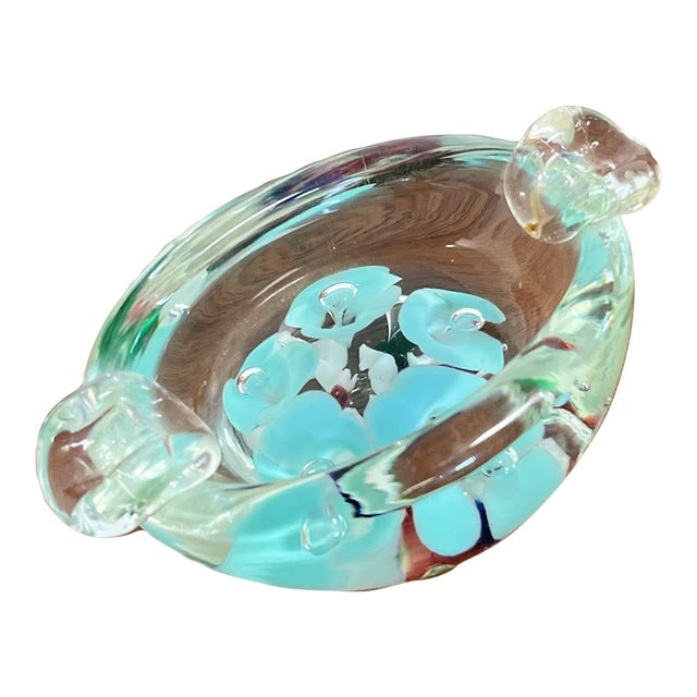 Small Crystal Murano Bowl: Small Crystal Murano Bowl A petite murano glass bowl with blue flower accents. It's a beautiful table top accessory perfect for holding earring and rings. 4.75" wide 3" deep 2" tall Dimensions: 4.75"W