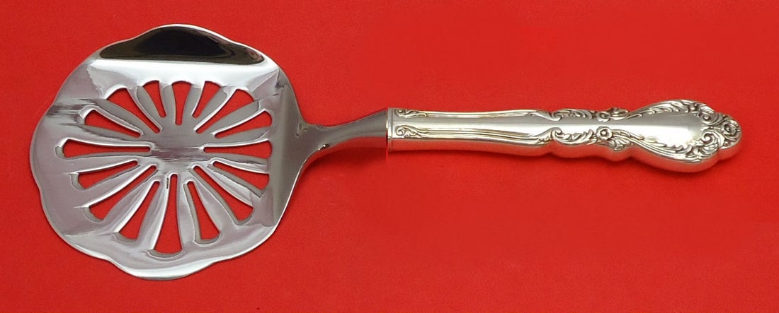 Old Charleston Sterling Silver Tomato Server by International: Old Charleston Sterling Silver Tomato Server by International This exquisite Old Charleston tomato server features a hollow handle crafted from Sterling Silver with a stainless implement. Measuring ap