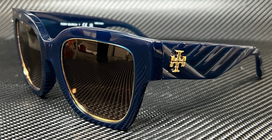 Tory Burch TY7180U 165613 Navy Brown Gradient Square Sunglasses: Tory Burch TY7180U 165613 Navy Brown Gradient Square Sunglasses These Tory Burch TY7180U sunglasses feature a stylish square design with a navy blue frame and gradient brown lenses. Crafted from durab