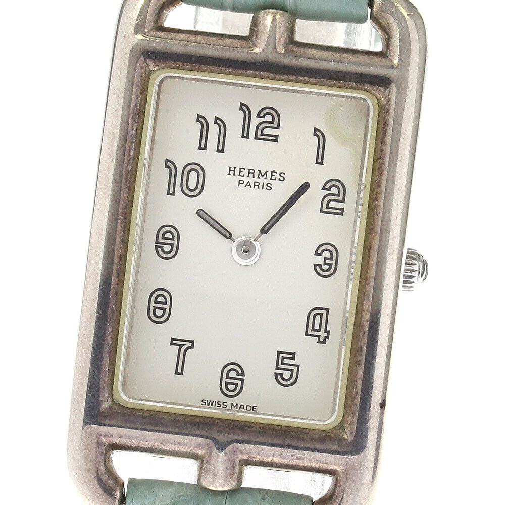 HERMES Nantucket Quartz Ladies Watch SV925 Silver Dial Leather Strap: HERMES Nantucket Quartz Ladies Watch SV925 Silver Dial Leather Strap This HERMES Nantucket Quartz Ladies Watch features a rectangular case made from SV925 silver with a silver dial. The watch has slig