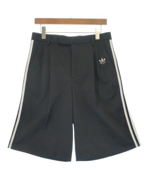 GUCCI Black Shorts Size 46 with White Side Stripes: GUCCI Black Shorts Size 46 with White Side Stripes These GUCCI shorts in black feature a pleated front design and white side stripes. They are sized for men at 46 (approximately Medium) and are of reg