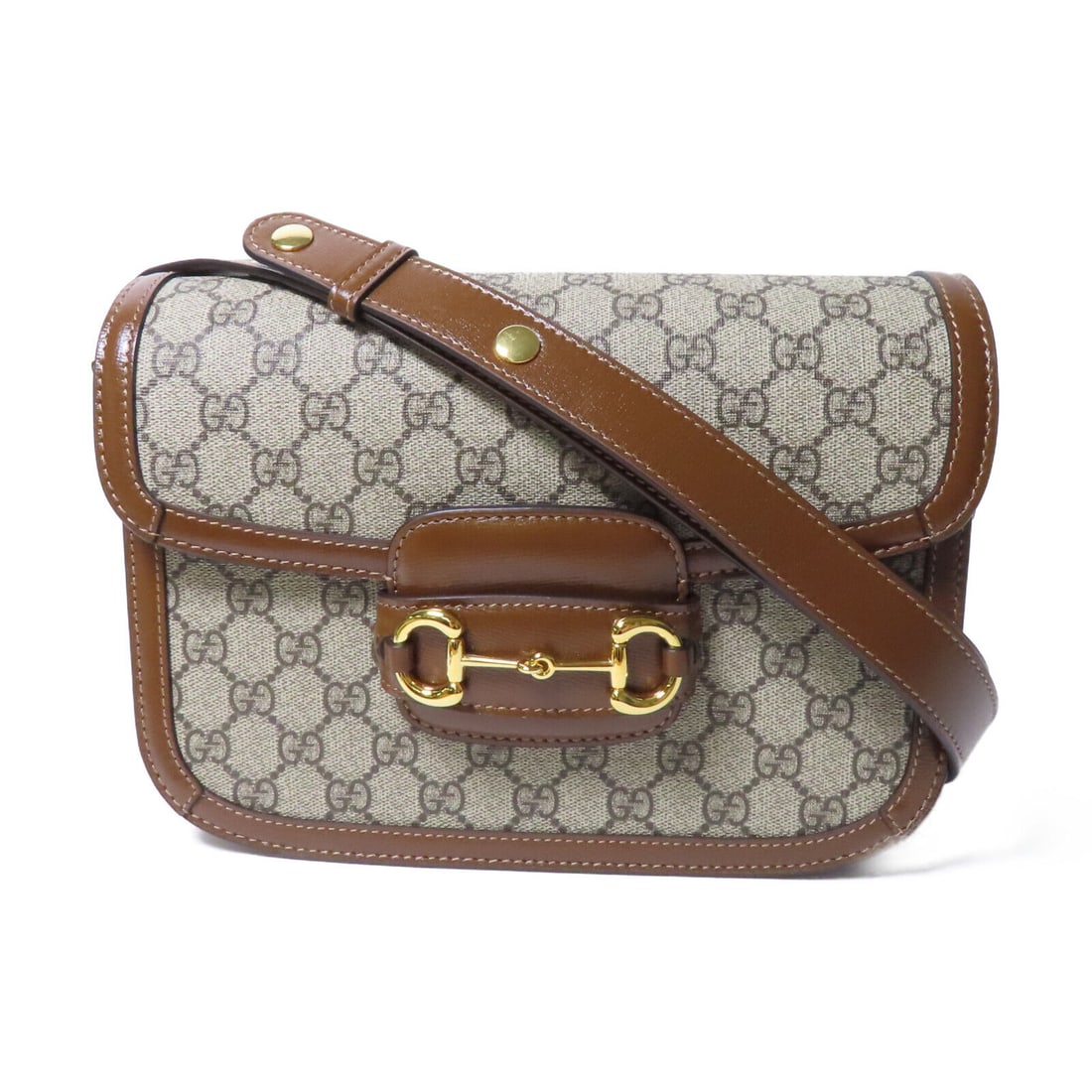 GUCCI Brown GG Horsebit 1955 Shoulder Bag PVC Canvas 6.9x3.0x9.8 inches: GUCCI Brown GG Horsebit 1955 Shoulder Bag PVC Canvas 6.9x3.0x9.8 inches The GUCCI GG GHW Horsebit 1955 Shoulder Bag is crafted from durable PVC coated canvas in a rich brown color. This stylish should