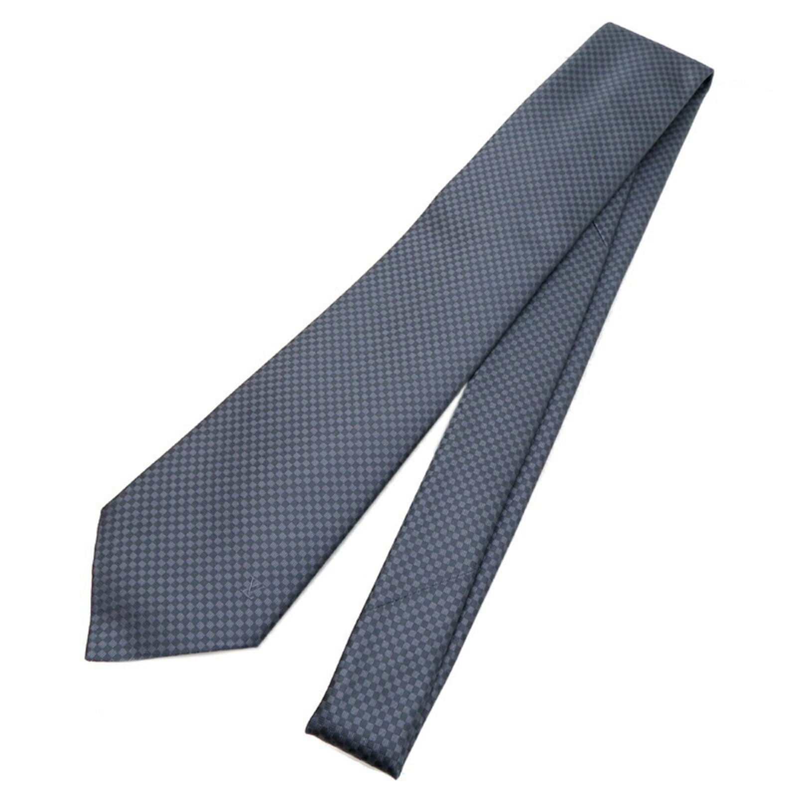 Louis Vuitton Grey Silk Cravat Tie for Men M78749: Louis Vuitton Grey Silk Cravat Tie for Men M78749 This Louis Vuitton cravat tie for men is crafted from 100% silk in a sophisticated gray color. The tie features a micro damier pattern, making it a st