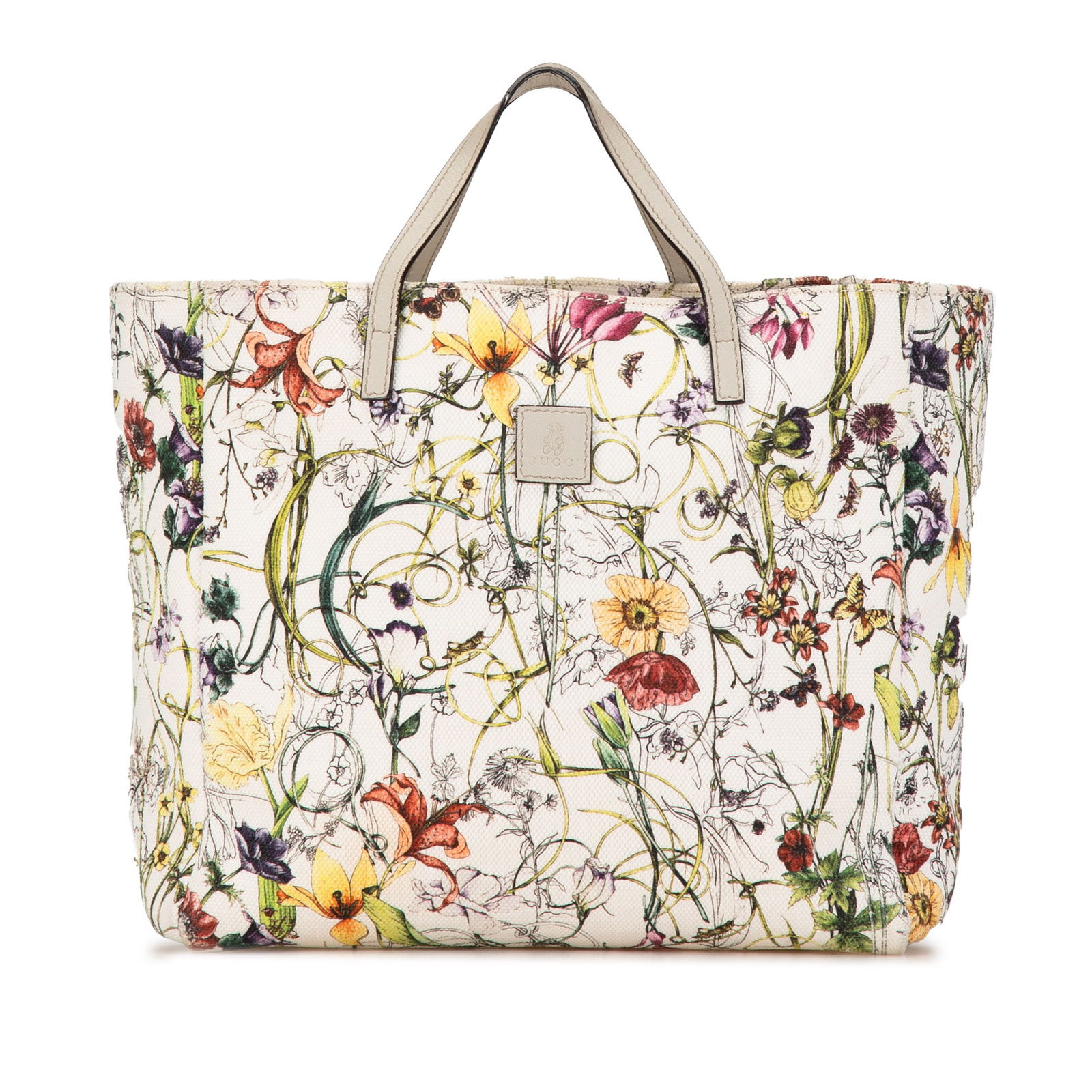 Gucci Kids Canvas Flora Handbag in White with Leather Straps: Gucci Kids Canvas Flora Handbag in White with Leather Straps This Gucci Kids Canvas Flora Handbag features a canvas body, flat leather straps, and an open top design. The interior includes a slip pock