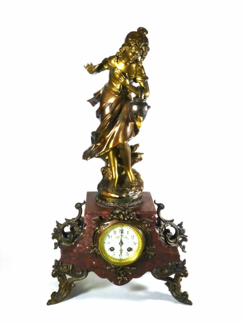 Antique Desk Clock with Woman and Water Bucket Design: Antique Desk Clock with Woman and Water Bucket Design This Large Figural Clock features a decorative design of a woman holding a water bucket, making it an exquisite addition for antique collectors. I