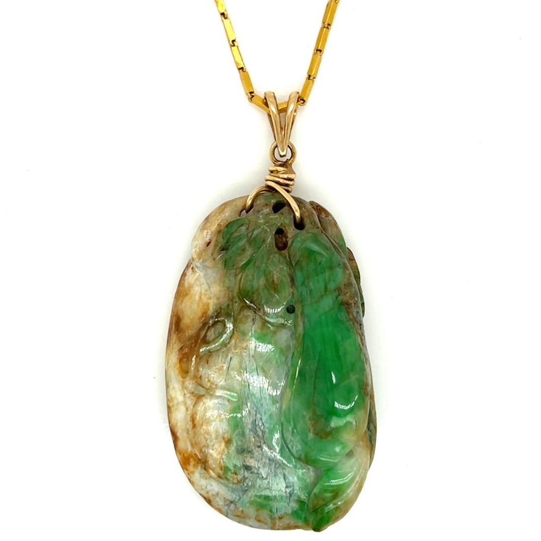 24K Gold Chain with 14K Bail and Carved Jade Pendant: 24K Gold Chain with 14K Bail and Carved Jade Pendant This exquisite chain features a stunning carved jade pendant. The pendant measures 57 x 34mm and is made from other gemstones. The chain itself is 