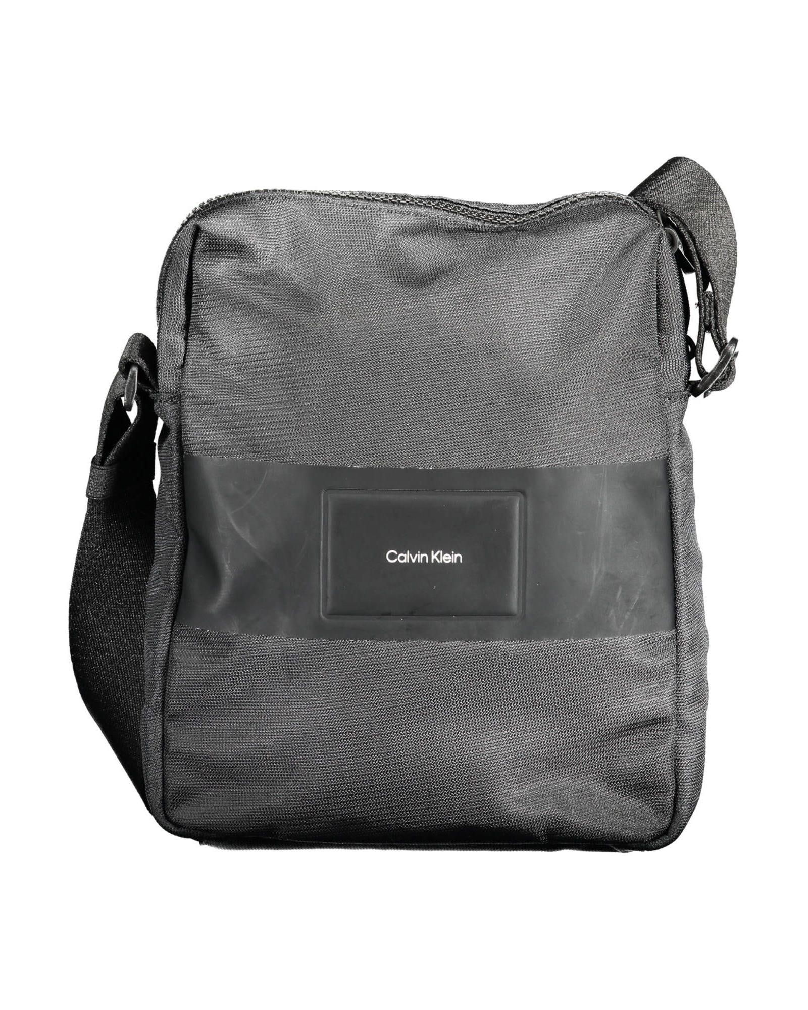 Calvin Klein Black Crossbody Bag 100 Percent Recycled Polyester Adjustable Strap: Calvin Klein Black Crossbody Bag 100 Percent Recycled Polyester Adjustable Strap This black shoulder bag is made of 100% recycled polyester and features an adjustable shoulder strap one inside pocket