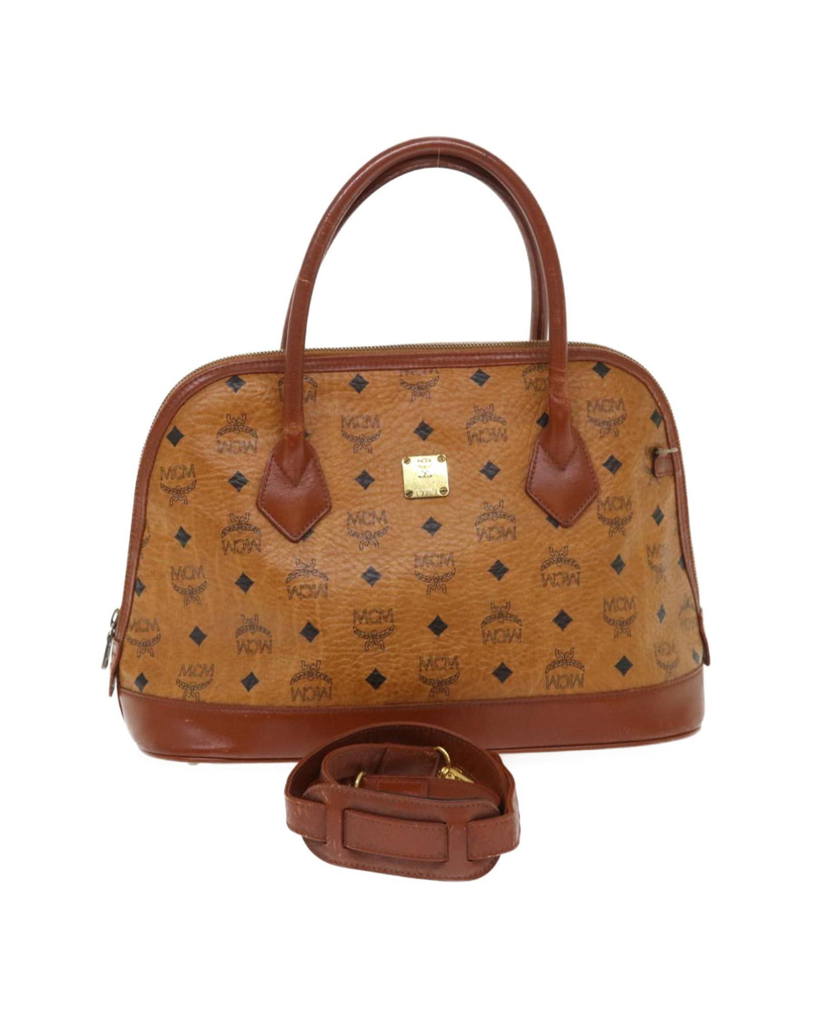MCM MCM Patricia Dome Satchel Brown Leather Handbag: MCM MCM Patricia Dome Satchel Brown Leather Handbag This MCM Vicetos Logogram Hand Bag is a stylish and versatile accessory for women. It is crafted from high-quality PVC leather material in brown and