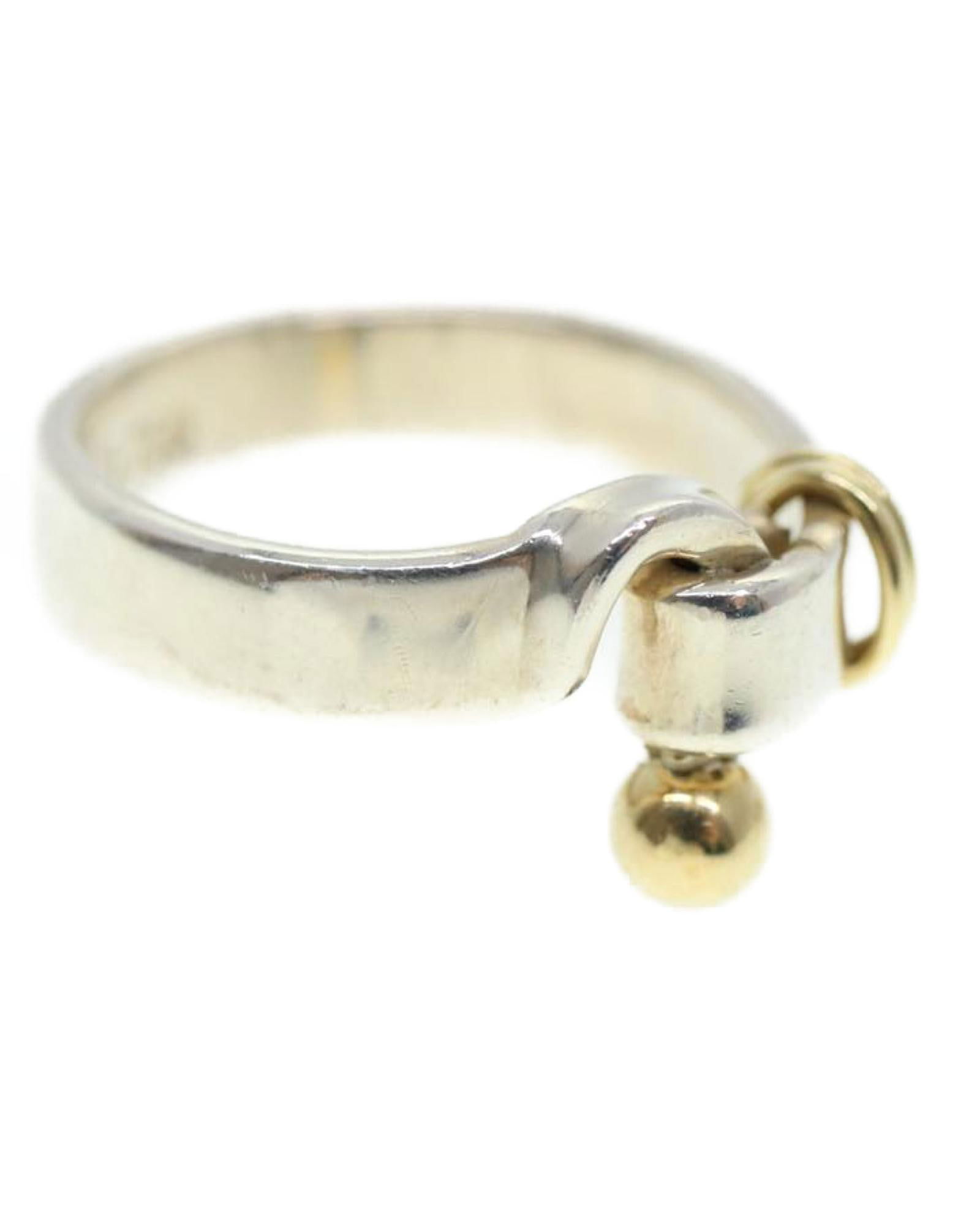 Tiffany & Co. Tiffany & Co. Knot Ring in Sterling Silver and 18k Gold: Tiffany & Co. Tiffany & Co. Knot Ring in Sterling Silver and 18k Gold This Tiffany & Co. Bangle Bracelet is crafted from 925/750 silver ensuring its authenticity and quality. It features a sleek desig