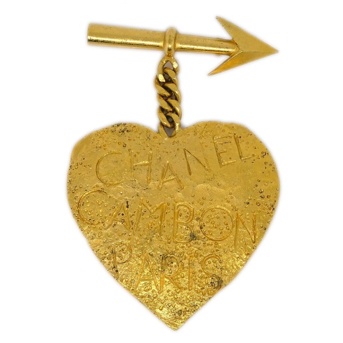 Chanel Gold Plated Bow And Arrow Heart Brooch 4 Inches: Chanel Gold Plated Bow And Arrow Heart Brooch 4 Inches This Chanel Bow And Arrow Heart Brooch Pin is a unique accessory that showcases a charming design. Crafted with gold-plated material, it features