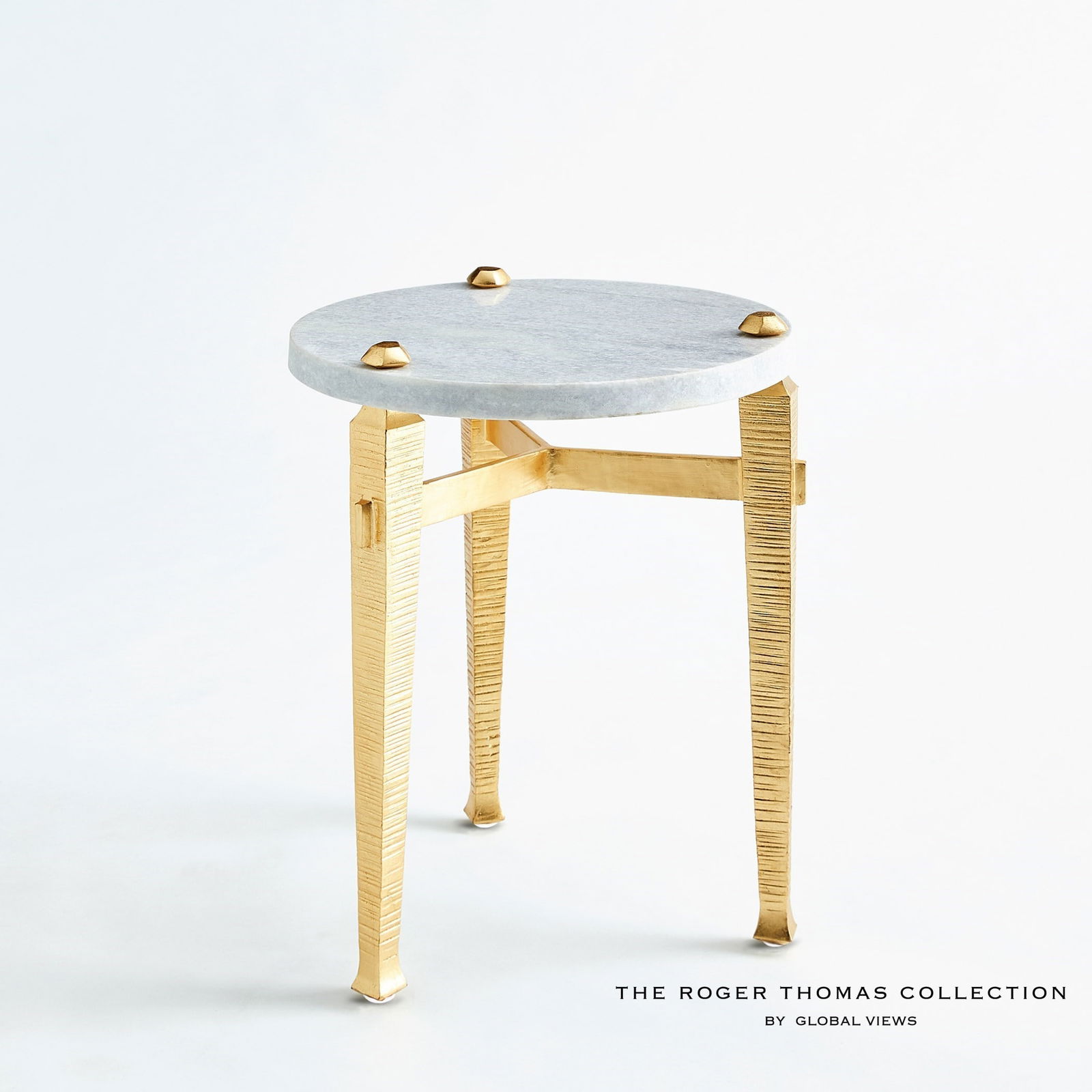 Roman Drinks Table In Gold: Roman Drinks Table In Gold The Roman collection by Roger Thomas draws inspiration from two notable sources. The silhouette of the leg was inspired by pieces crafted by Thomas Chippendale. The horizont