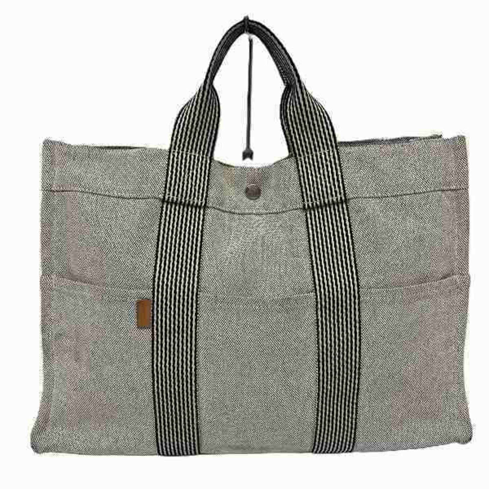 Hermes Fourre tout Grey Canvas Handbag: Hermes Fourre tout Grey Canvas Handbag The Hermes Fourre Tout is a stylish and practical tote bag designed for modern women. Crafted from durable canvas, this bag features a chic grey color and multip