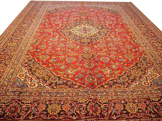 10' x 13' Handcrafted Red Persian Kashan Rug: 10' x 13' Handcrafted Red Persian Kashan Rug Experience the elegance of Persian artistry with this exquisite handmade Kashan rug. Crafted by skilled artisans, it features intricate floral motifs woven