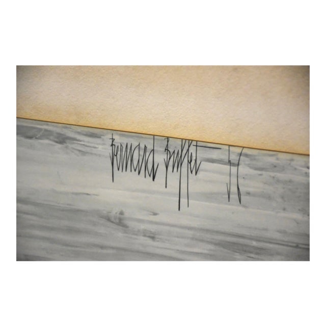 Paris Lithograph: Paris Lithograph This striking lithograph by renowned French artist Bernard Buffet captures the somber essence of Paris in a desolate landscape. Created in the late 20th century, Buffet's work reflect