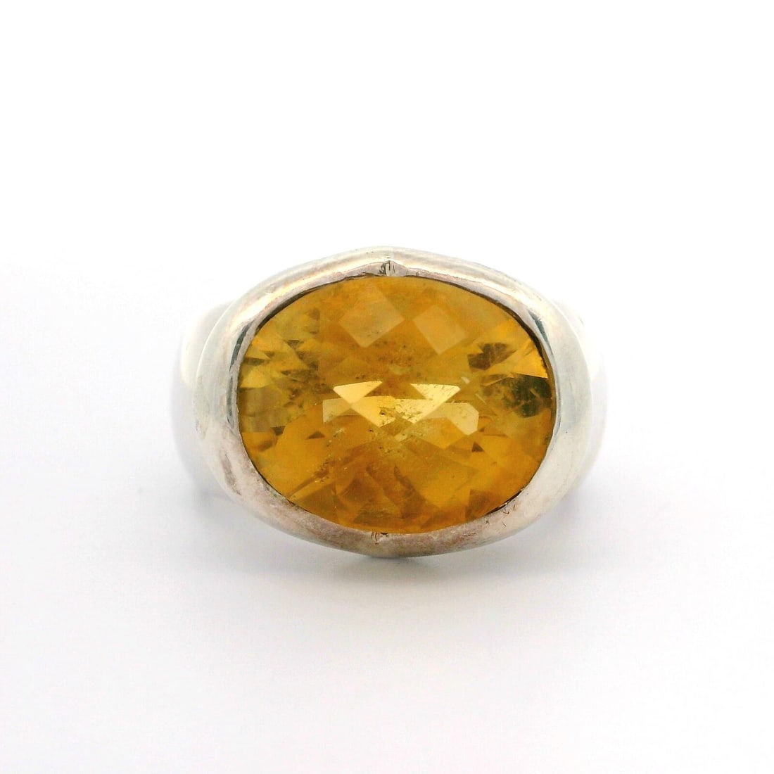 Estate Sterling Silver Oval Checkerboard Citrine Cocktail Ring: Estate Sterling Silver Oval Checkerboard Citrine Cocktail Ring Elevate your accessory collection with this stunning Estate Sterling Silver Oval Checkerboard Citrine Solitaire Cocktail Ring. This exqui