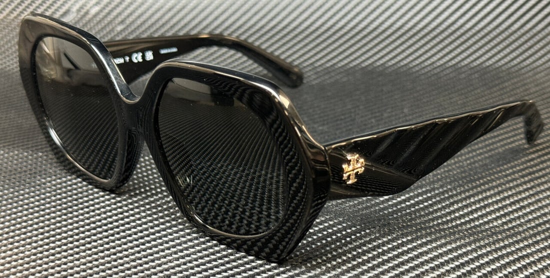 Tory Burch Black Dark Grey Women's Sunglasses: Tory Burch Black Dark Grey Women's Sunglasses Elevate your style with these Tory Burch oversized sunglasses, featuring a chic geometric frame in a sleek black color. Designed for the fashion-forward w