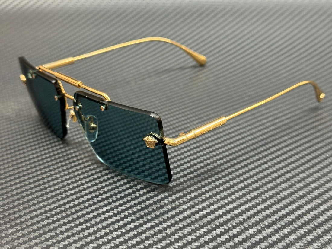Versace Gold Blue Women's Sunglasses: Versace Gold Blue Women's Sunglasses Elevate your style with these stunning Versace VE2245 sunglasses. Featuring a luxurious gold frame with eye-catching blue rectangular lenses, these sunglasses are