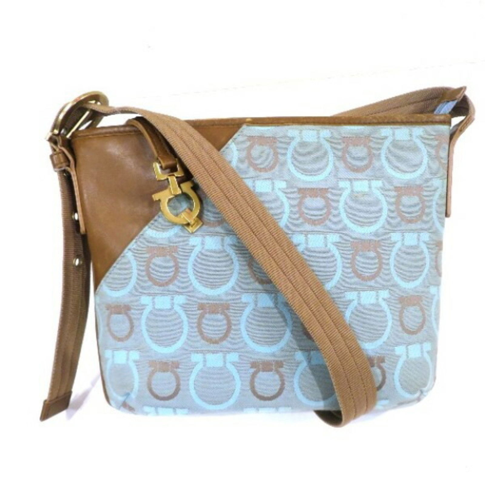 Gancini Canvas Leather Shoulder Bag for Women: Gancini Canvas Leather Shoulder Bag for Women Introducing the Salvatore Ferragamo Gancini Shoulder Bag, a stylish accessory designed for women. This bag features a chic combination of light blue and b