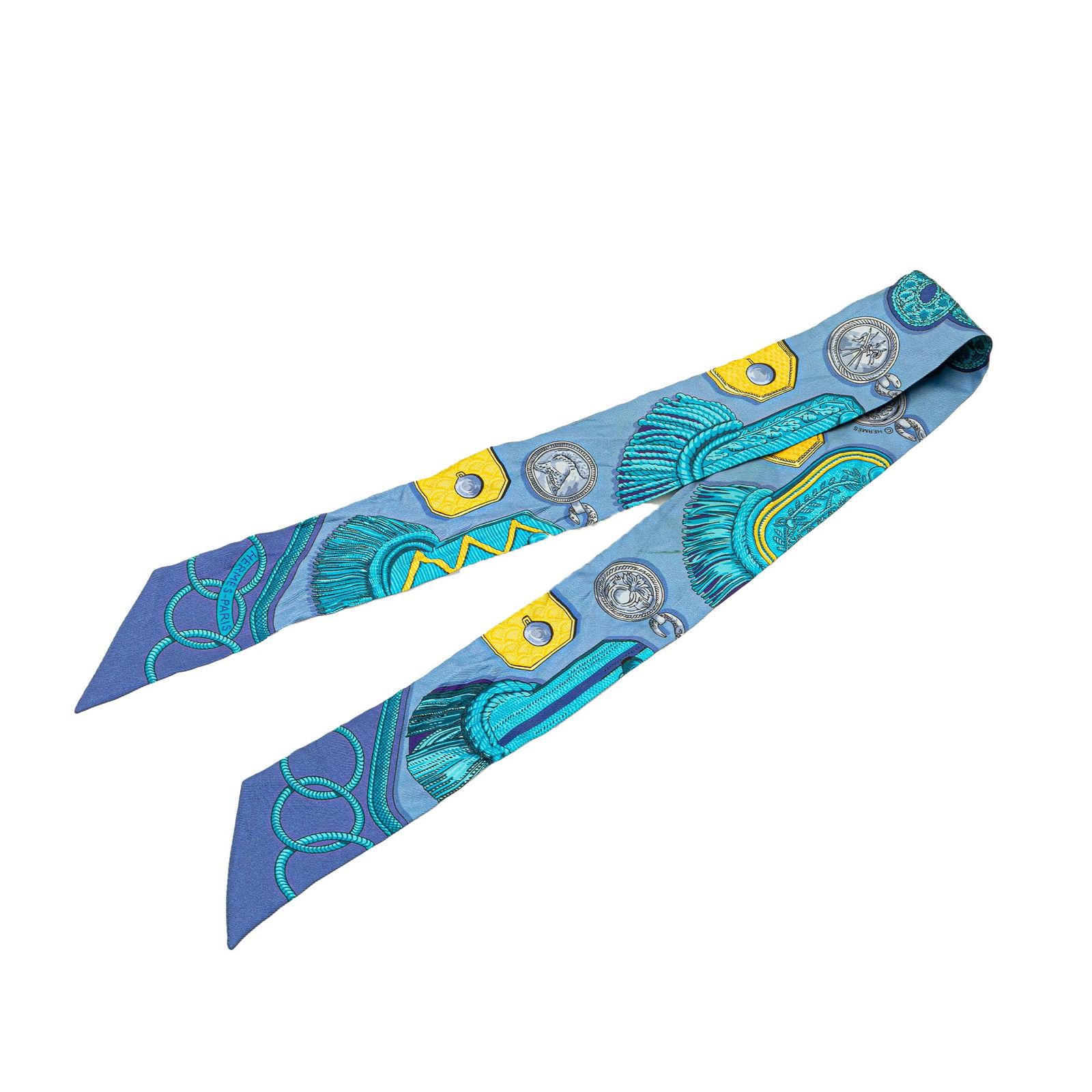 Hermes Blue Epaulettes Silk Twilly Scarf 85 x 5 cm: Hermes Blue Epaulettes Silk Twilly Scarf 85 x 5 cm Elevate your accessory collection with the Hermes Epaulettes Silk Twilly Scarf, showcasing a stunning Epaulettes print on luxurious 100% silk. This s