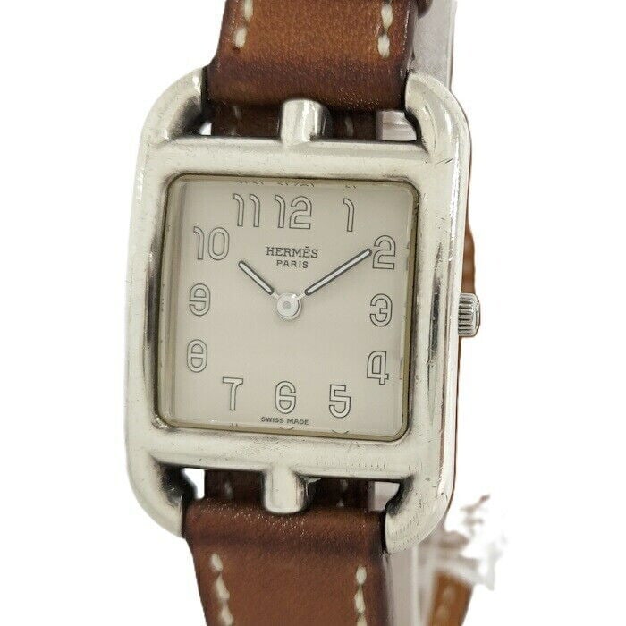 HERMES Cape Got Quartz Ladies Watch: HERMES Cape Got Quartz Ladies Watch This elegant HERMES Cape Got Quartz ladies wristwatch combines sophistication with functionality. Featuring a rectangular silver-tone stainless steel case, this tim