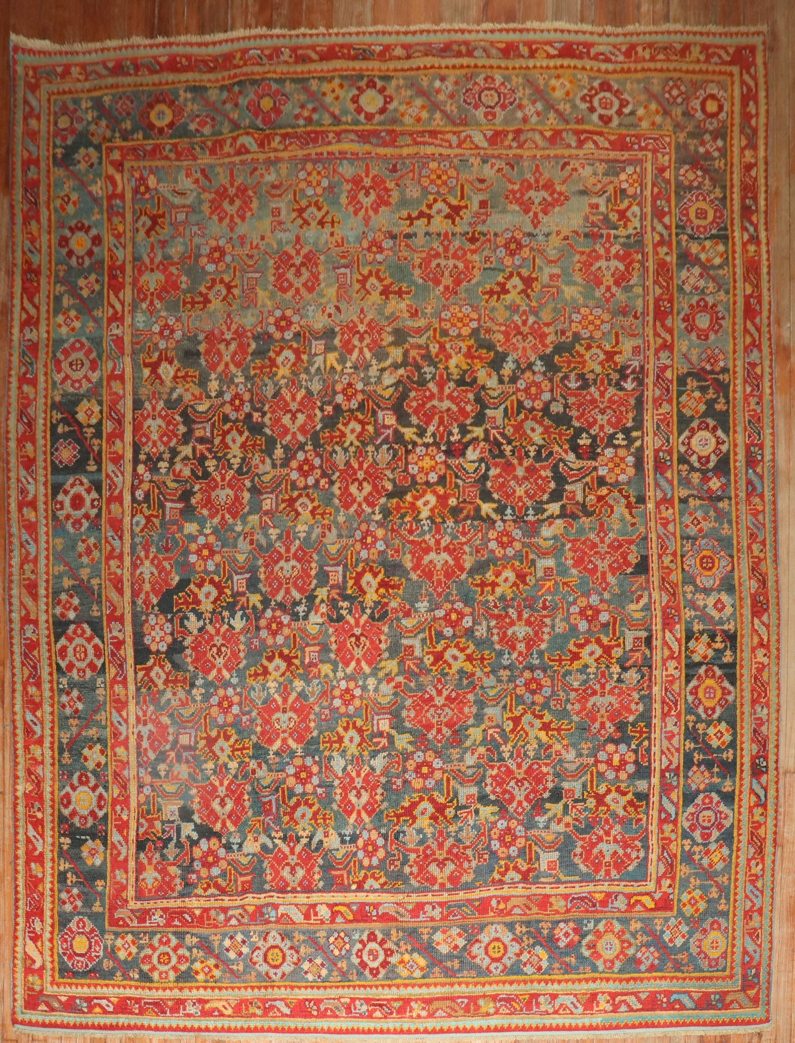 Early 20th Century Turkish Oushak Rug 9' 6" x 12' 10": Early 20th Century Turkish Oushak Rug 9' 6" x 12' 10" This exquisite early 20th Century Turkish Antique Oushak Rug features intricate floral patterns in vibrant red, blue, and gold tones. Perfect for