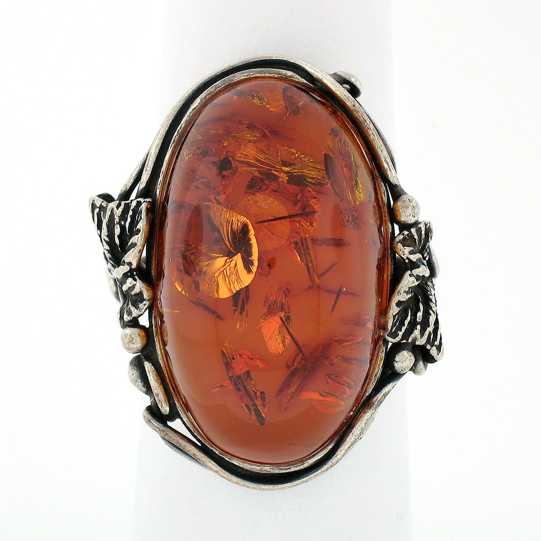 Vintage .925 Silver Leaf Design Amber Cocktail Ring 6.5: Vintage .925 Silver Leaf Design Amber Cocktail Ring 6.5 This exquisite vintage cocktail ring showcases a stunning handcrafted design in solid .925 sterling silver, featuring a large oval cabochon ambe