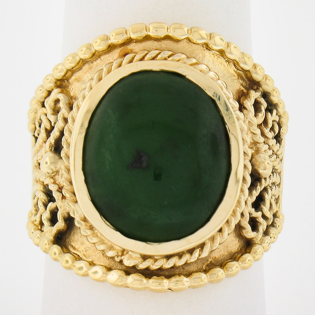 Vintage 14k Yellow Gold Oval Cabochon Cut Jade Cigar Band Ring: Vintage 14k Yellow Gold Oval Cabochon Cut Jade Cigar Band Ring This stunning vintage wide cigar band ring is expertly crafted from solid 14k yellow gold and features a captivating Nephrite Jade stone