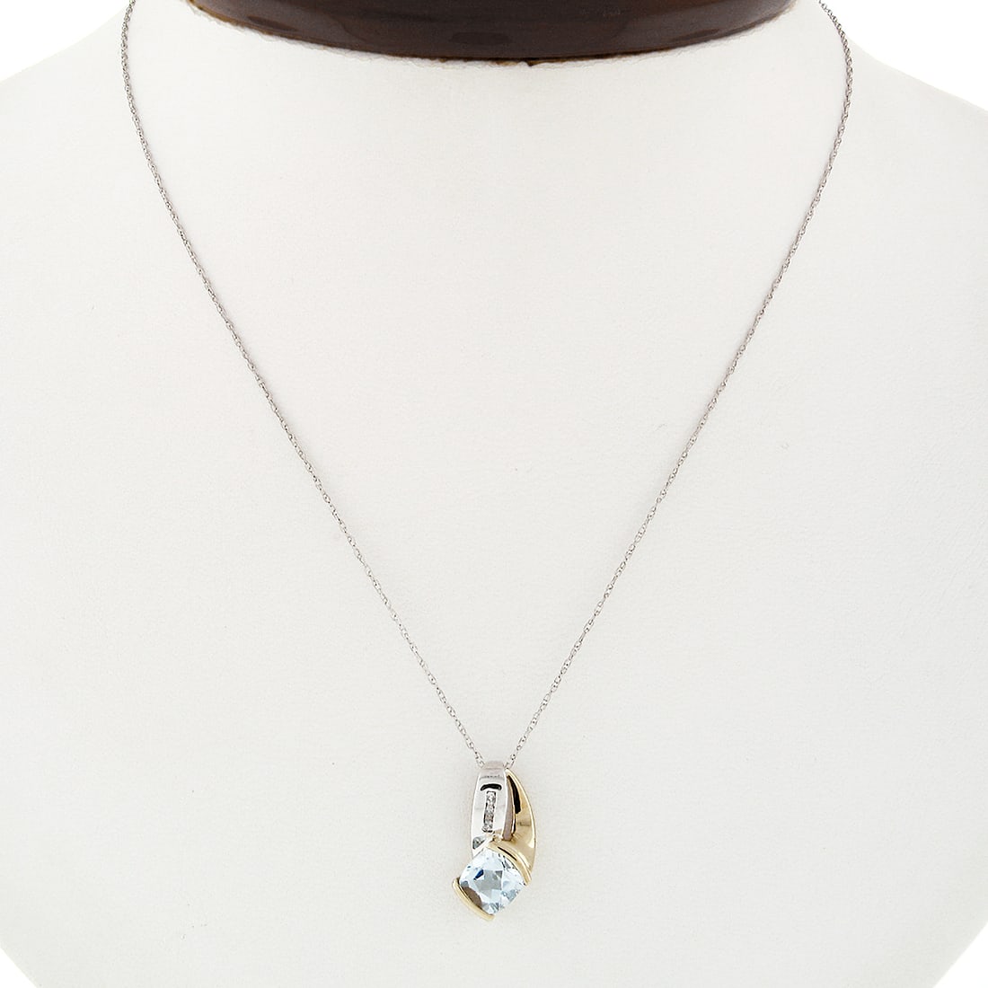 Petite 10K Two Tone Gold Blue Topaz Diamond Pendant Necklace 0.56ctw: Petite 10K Two Tone Gold Blue Topaz Diamond Pendant Necklace 0.56ctw This stunning Petite 10K Two Tone Gold Channel Blue Topaz and Diamond Pendant Necklace features a beautiful overlap design crafted 