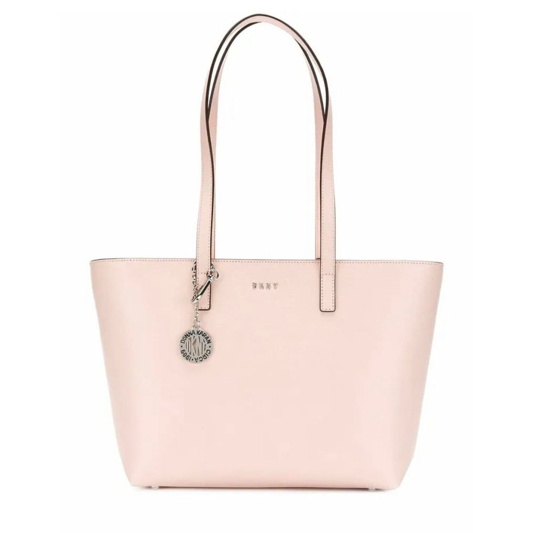 DKNY Pink PVC Tote Bag with Silver Hardware and Logo Charm: DKNY Pink PVC Tote Bag with Silver Hardware and Logo Charm The DKNY Nude Leather Shopper Bag is a stylish and functional tote that showcases a solid pink exterior made of durable PVC. This medium-size