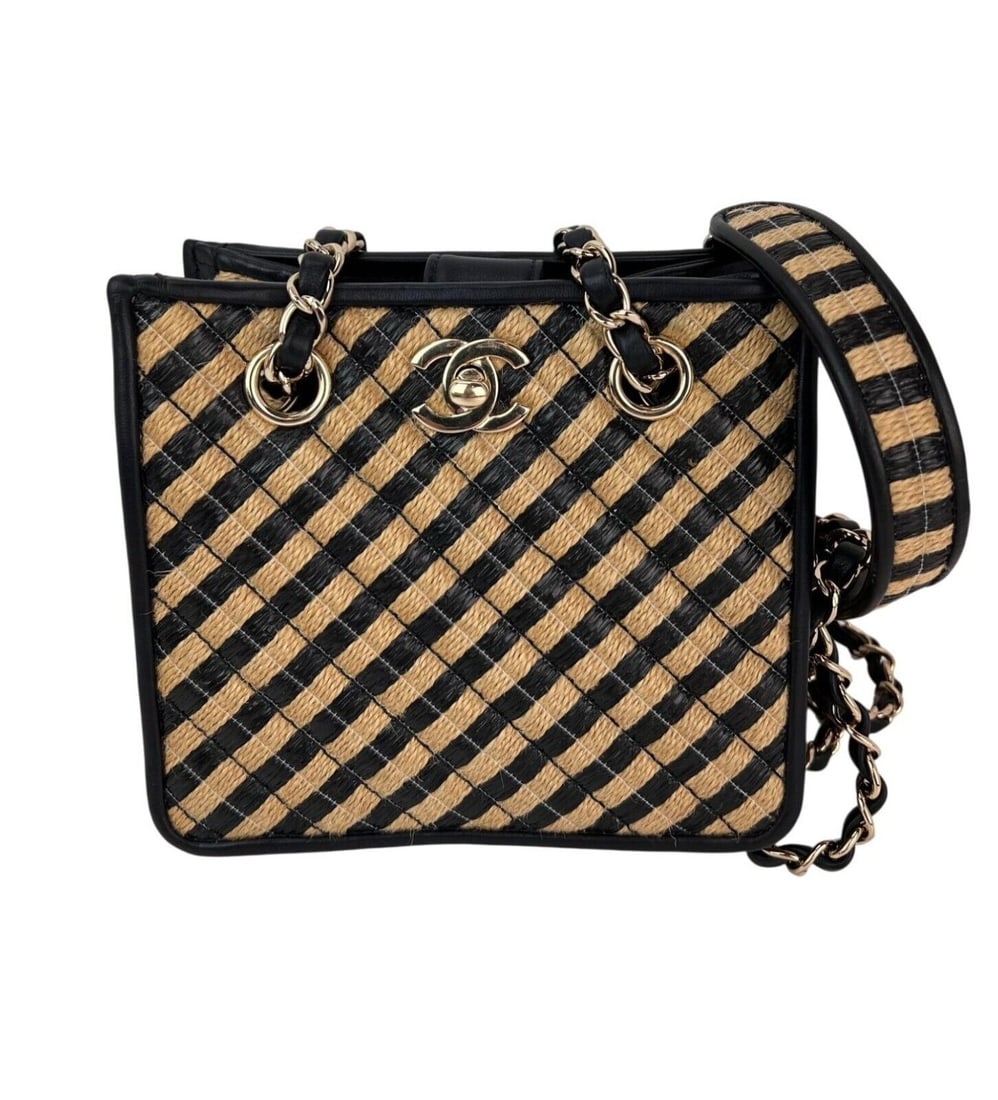 Chanel Jungle Bucket Bag Striped Raffia Black Beige Shoulder Bag: Chanel Jungle Bucket Bag Striped Raffia Black Beige Shoulder Bag Introducing the Chanel Raffia Jute Striped Urban Jungle Bucket Bag, a stylish accessory perfect for both casual and formal occasions. T