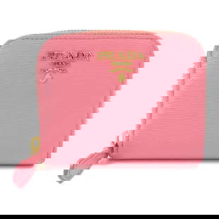 PRADA Pink Calfskin Coin Purse with GHW Closure: PRADA Pink Calfskin Coin Purse with GHW Closure This elegant PRADA coin purse is crafted from luxurious calfskin leather in a charming pink hue. Designed for functionality, it features a secure frame